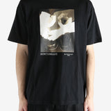 Black t-shirts worn by a person, showing the t-shirts fit