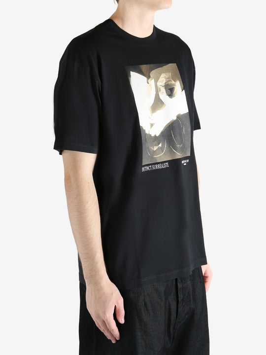 Black t-shirts worn by a person, showing the t-shirts fit