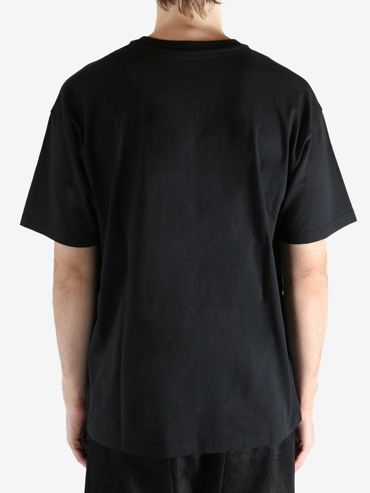Black t-shirts worn by a person, showing the t-shirts fit