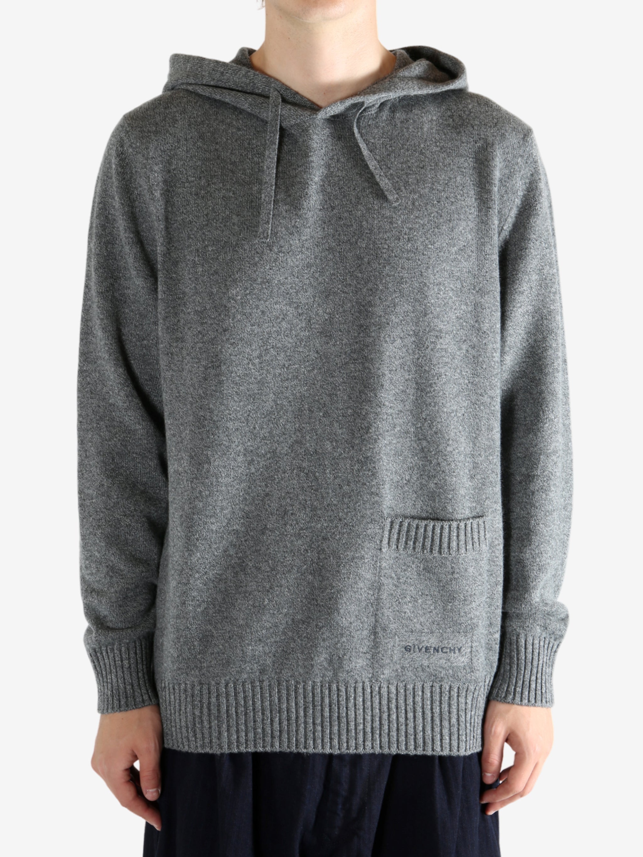 Grey hoodie worn by a person, showing the hoodie fit