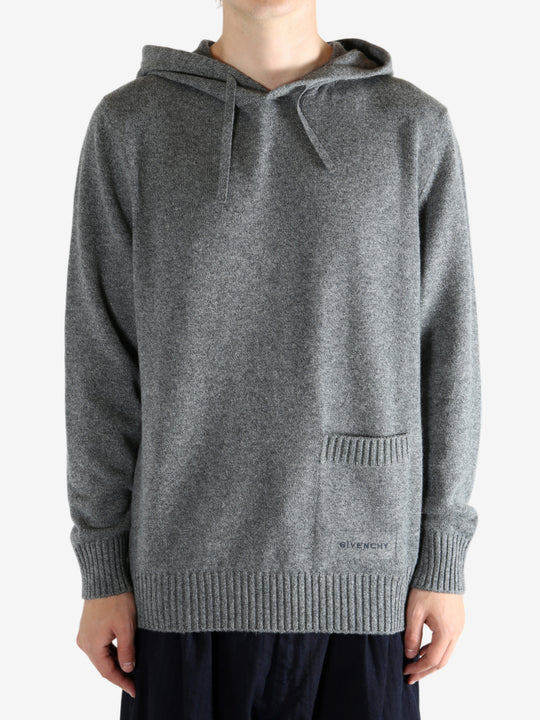 Grey hoodie worn by a person, showing the hoodie fit