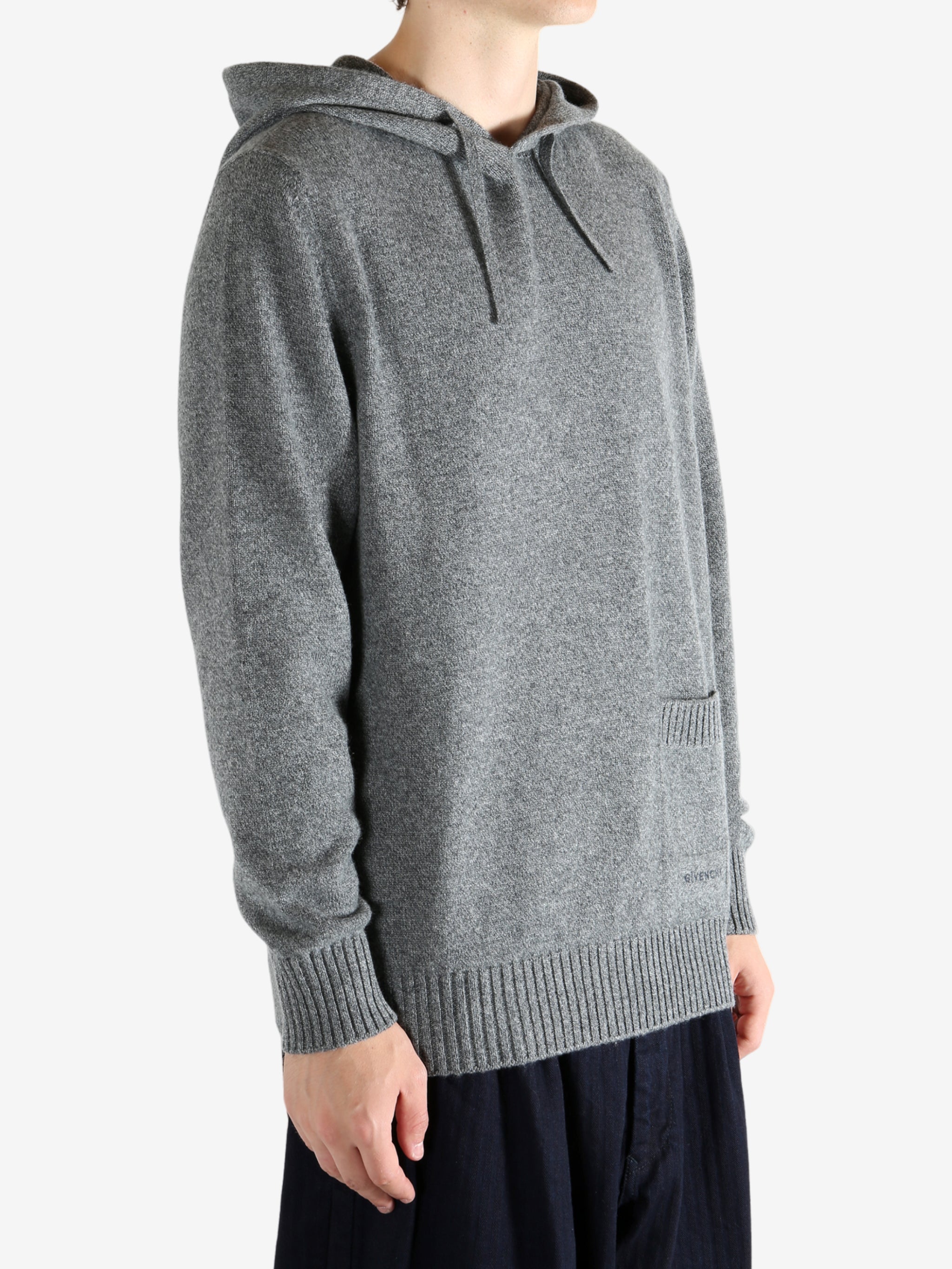 Grey hoodie worn by a person, showing the hoodie fit