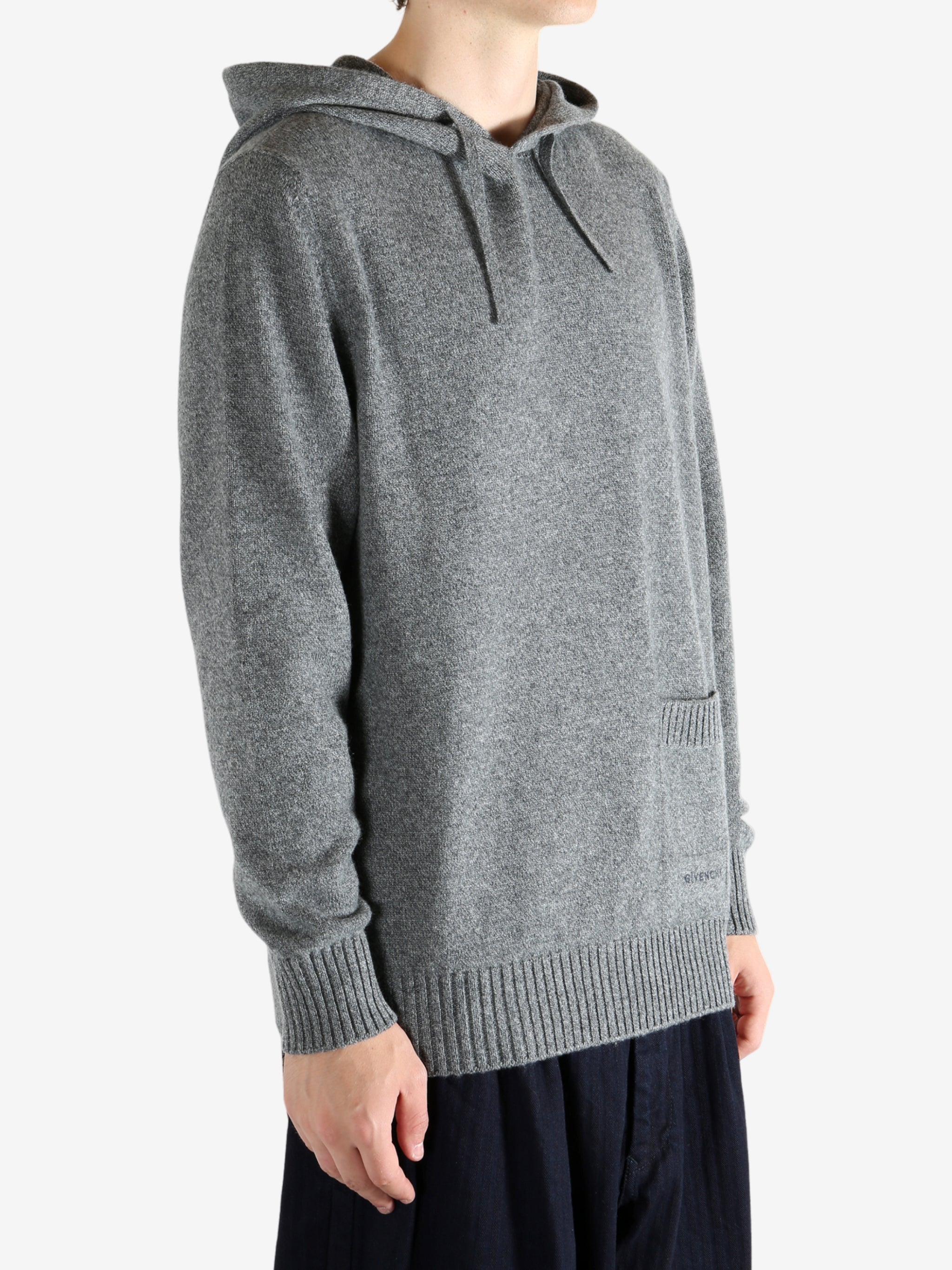 Grey hoodie worn by a person, showing the hoodie fit
