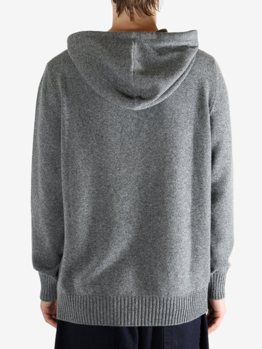 Grey hoodie worn by a person, showing the hoodie fit