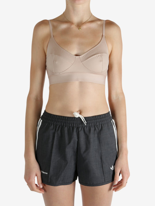 Tan top worn by a person, showing the top's fit