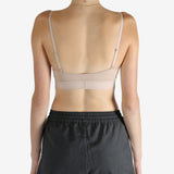 Tan top worn by a person, showing the top's fit