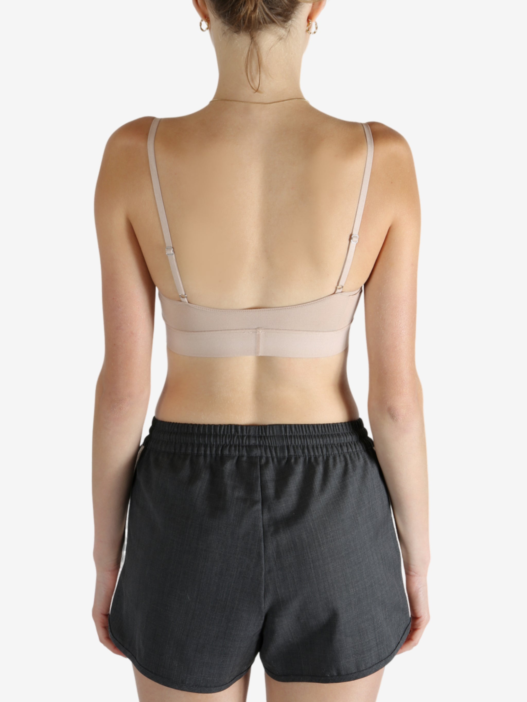 Tan top worn by a person, showing the top's fit