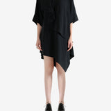 black dress worn by a person, showing the dress fit