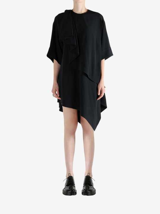 black dress worn by a person, showing the dress fit