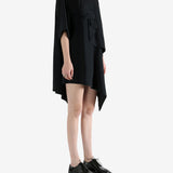 black dress worn by a person, showing the dress fit