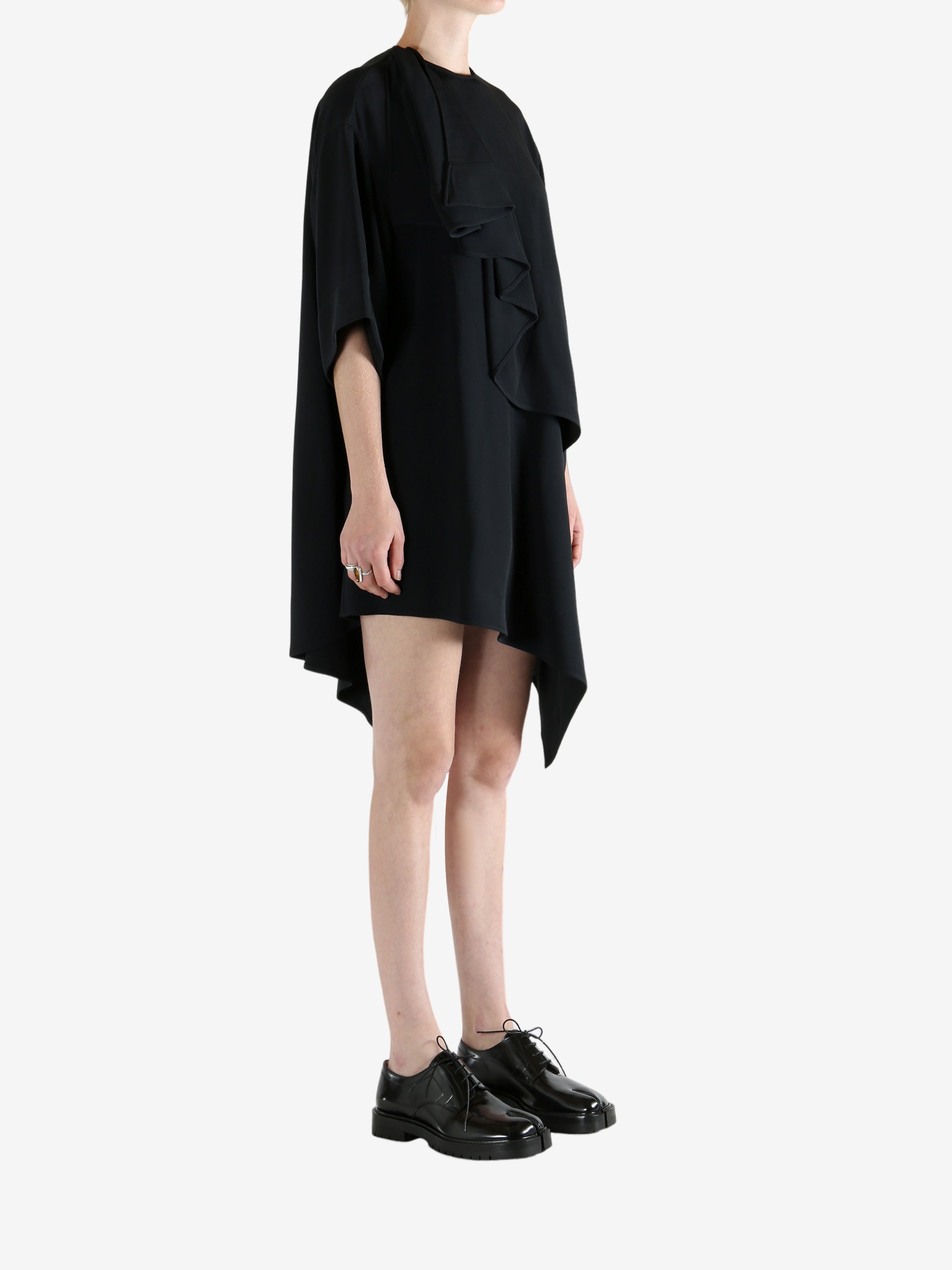 black dress worn by a person, showing the dress fit