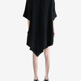 black dress worn by a person, showing the dress fit