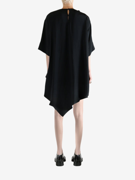 black dress worn by a person, showing the dress fit