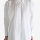 White shirt worn by a person, showing the shirt's fit