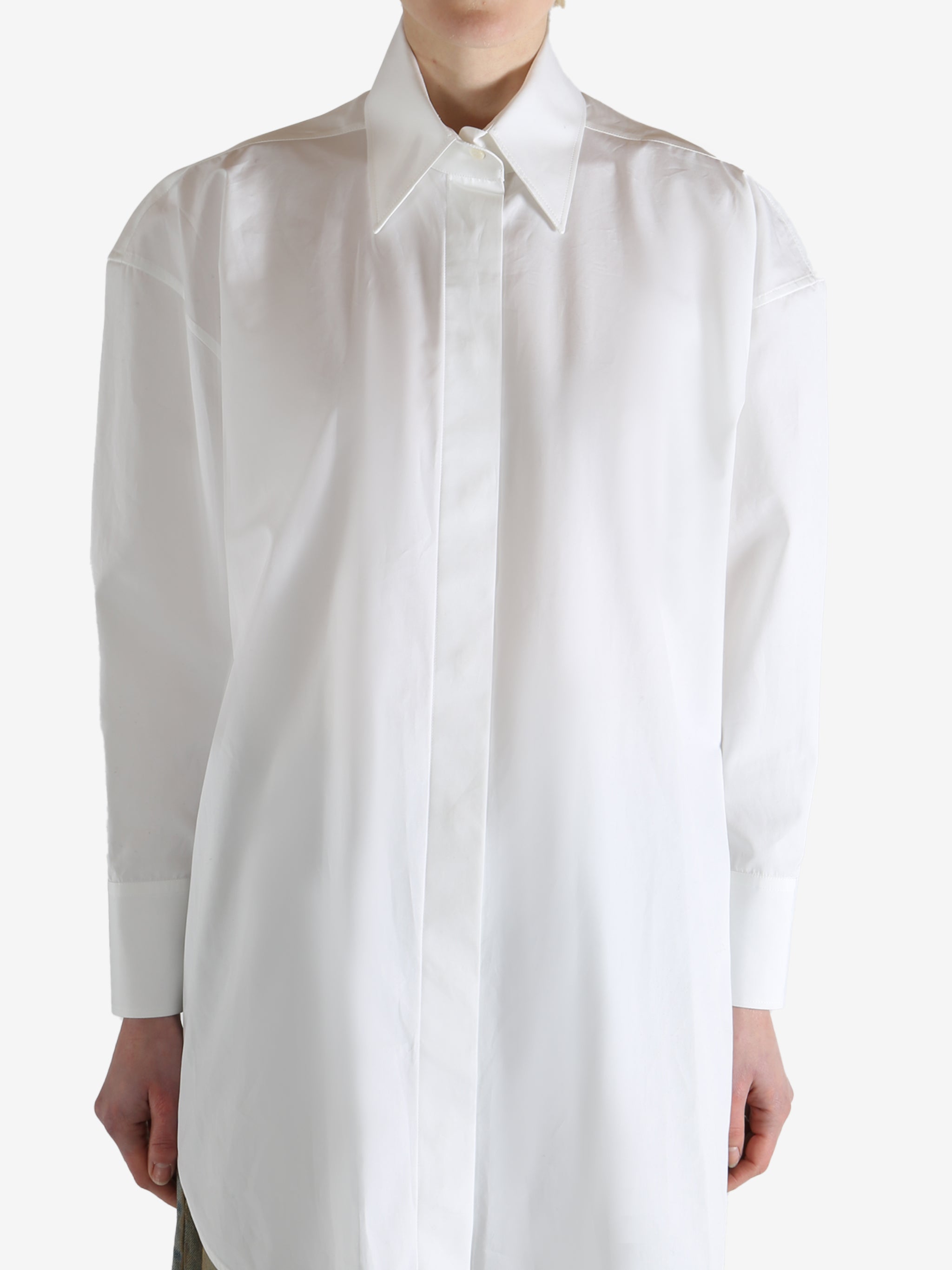 White shirt worn by a person, showing the shirt's fit