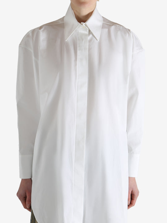 White shirt worn by a person, showing the shirt's fit