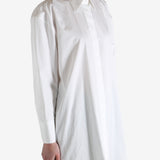 White shirt worn by a person, showing the shirt's fit