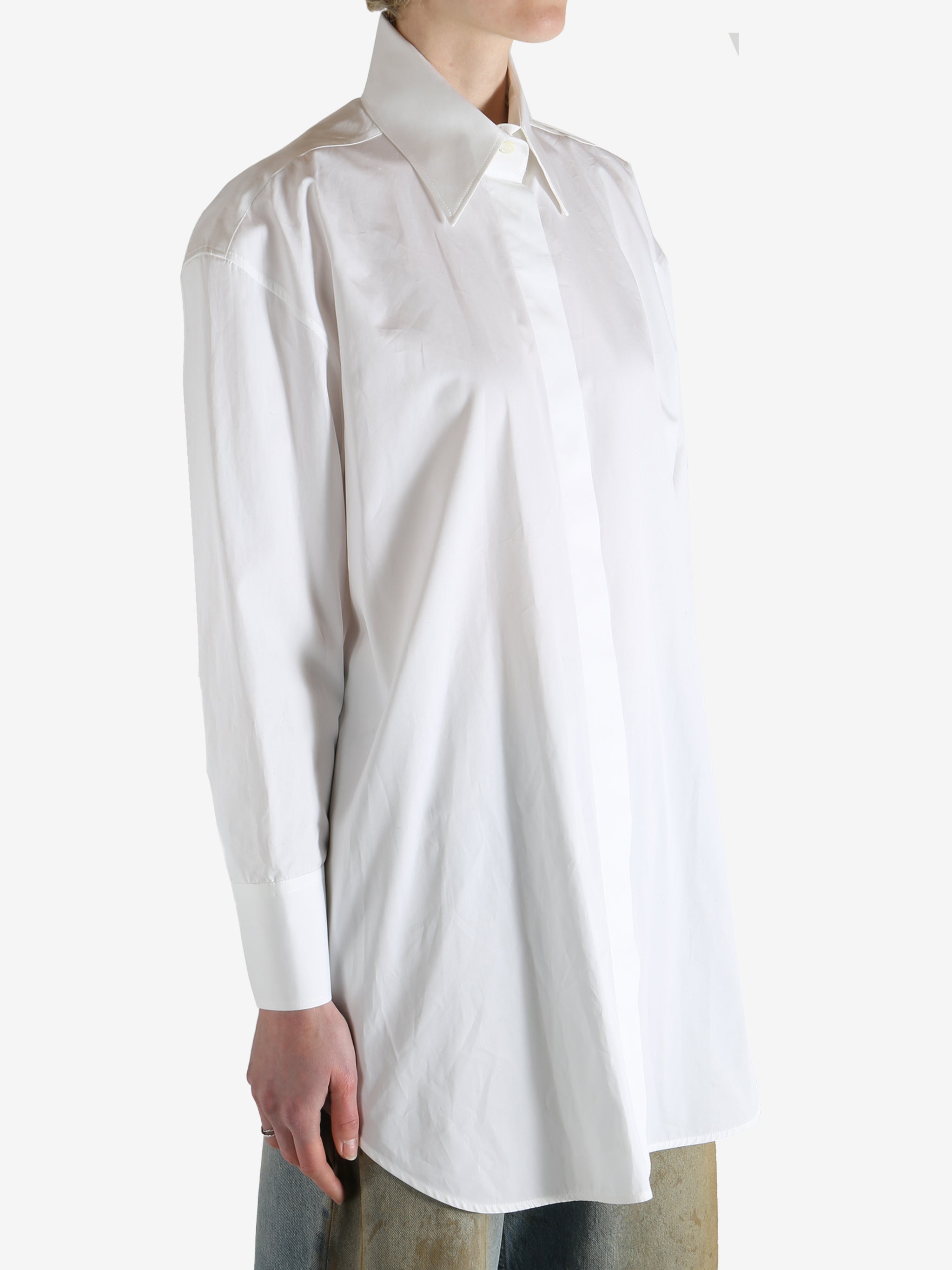White shirt worn by a person, showing the shirt's fit