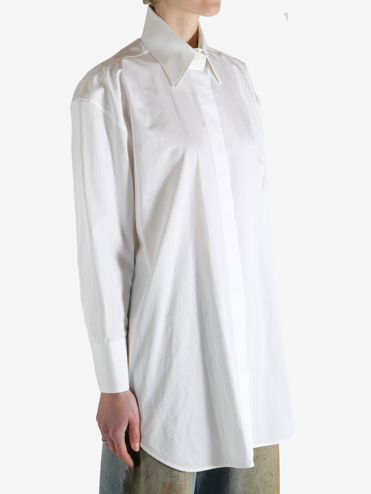 White shirt worn by a person, showing the shirt's fit