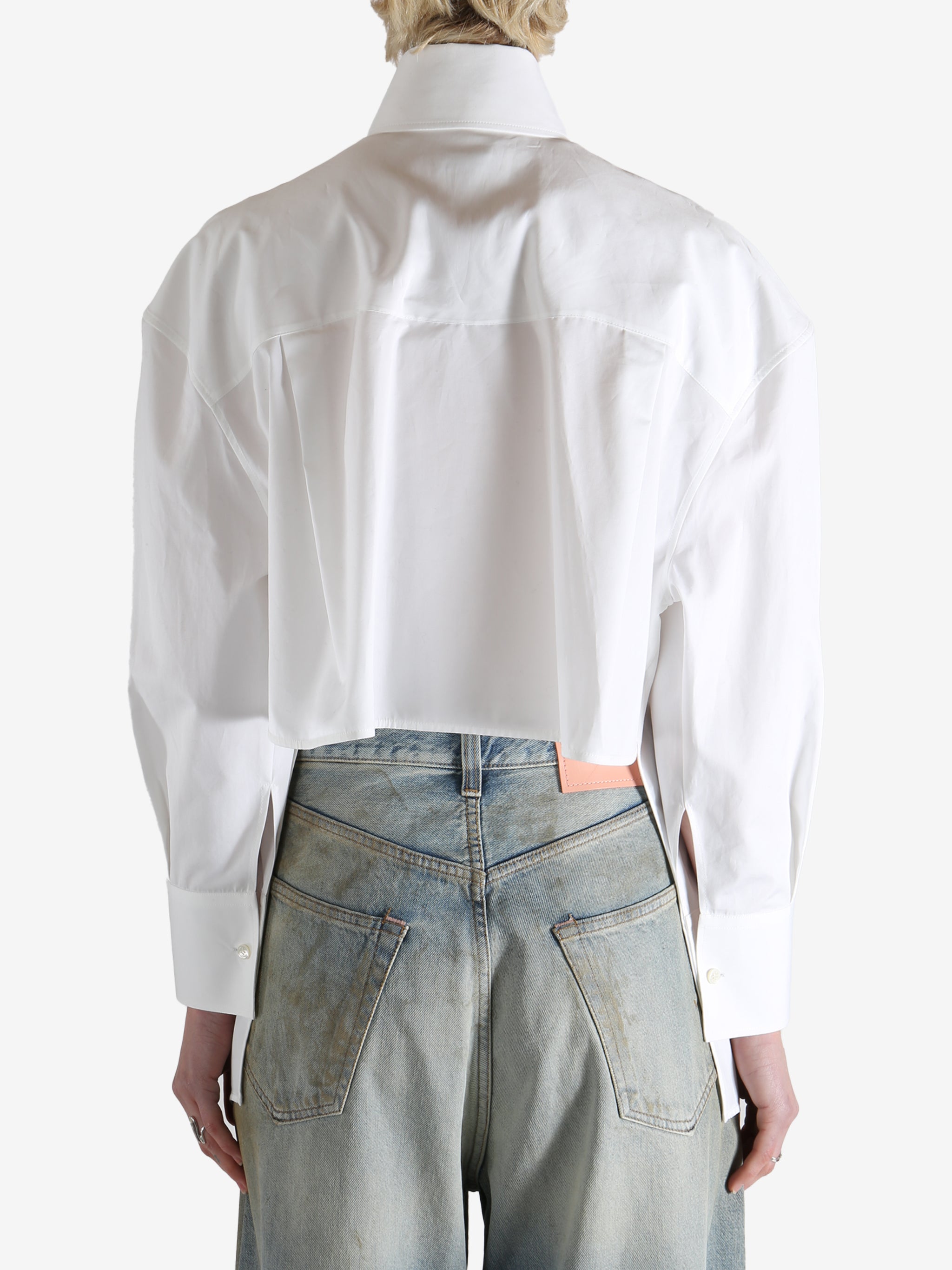 White shirt worn by a person, showing the shirt's fit