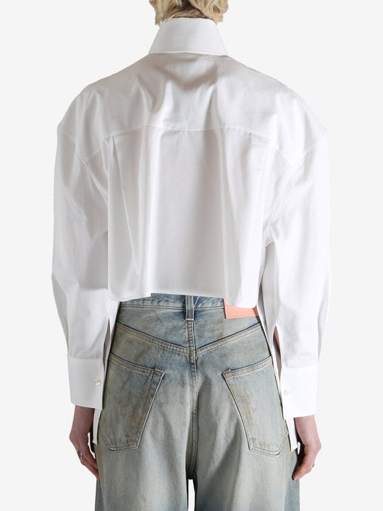 White shirt worn by a person, showing the shirt's fit