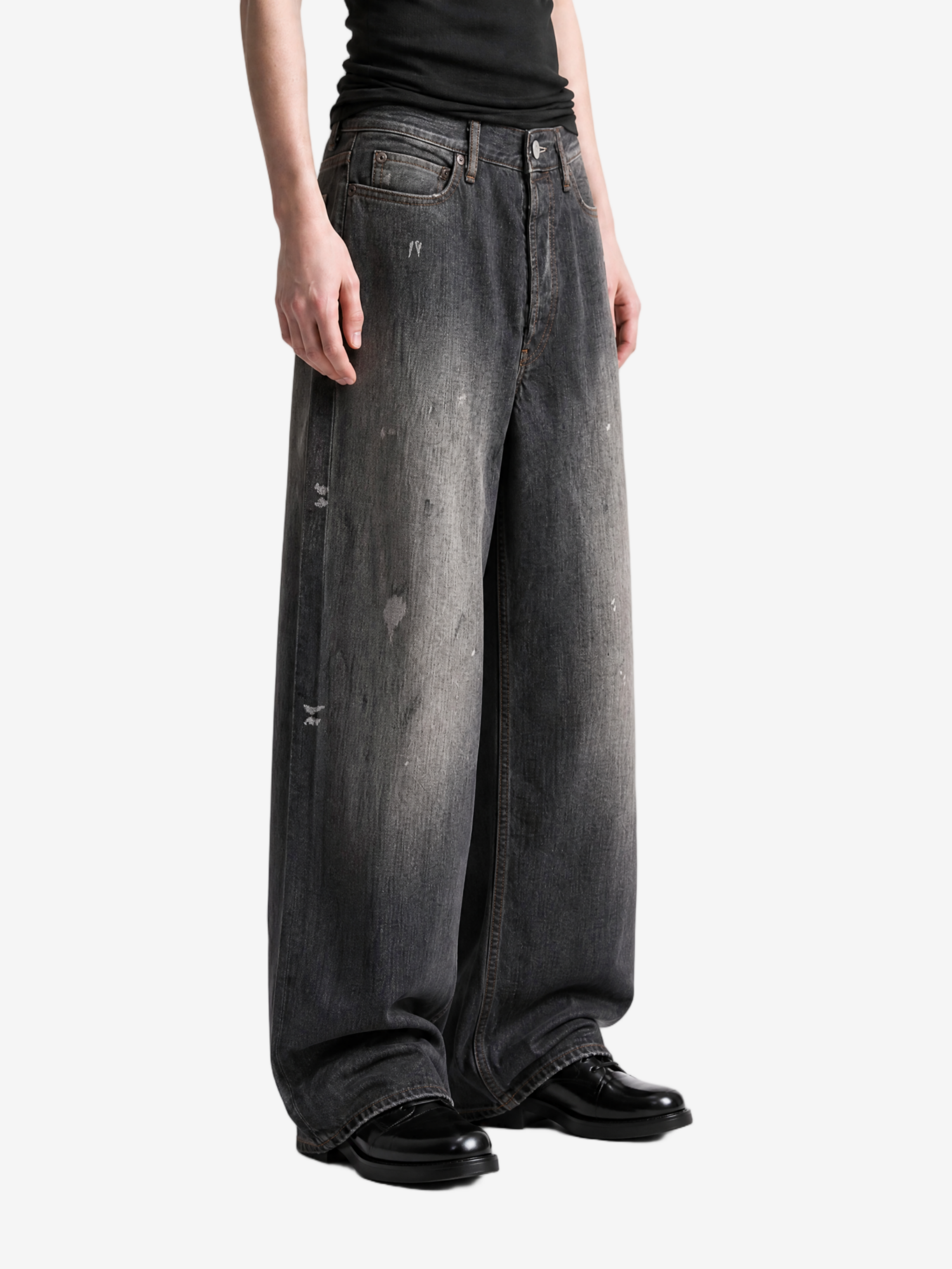 Black jeans worn by a person, showing the jeans fit