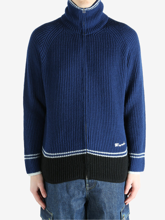 Blue sweater worn by a person, showing the sweater fit