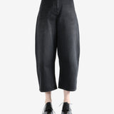 Black pants worn by a person, showing the pants fit