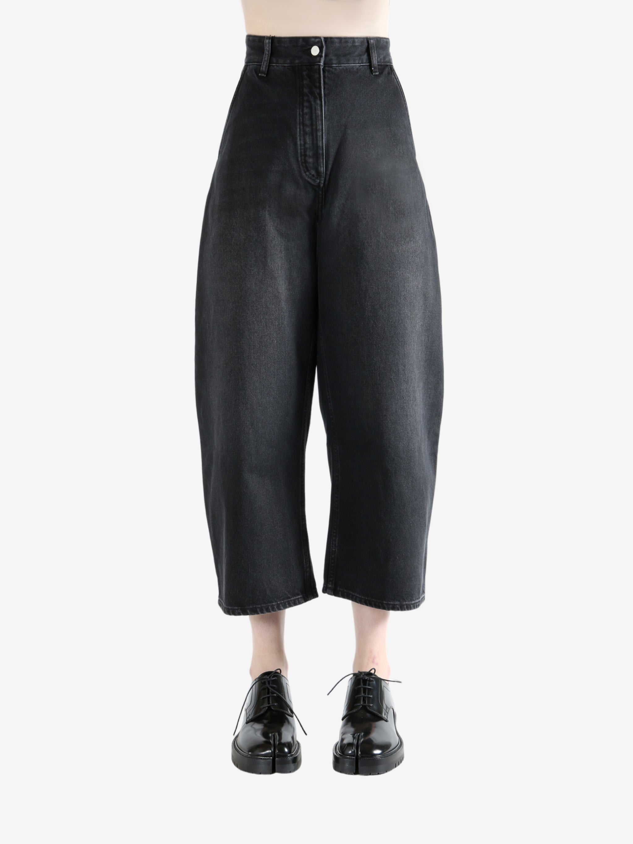 Black pants worn by a person, showing the pants fit