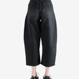 Black pants worn by a person, showing the pants fit