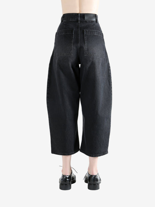 Black pants worn by a person, showing the pants fit