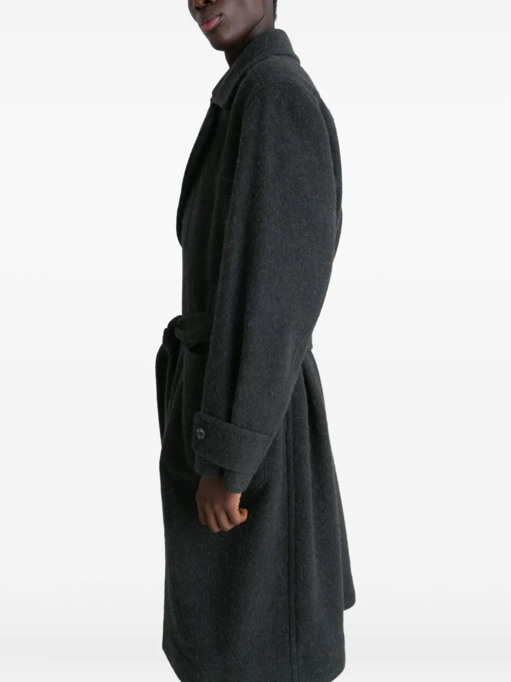 Black coat worn by a person, showing the coat fit