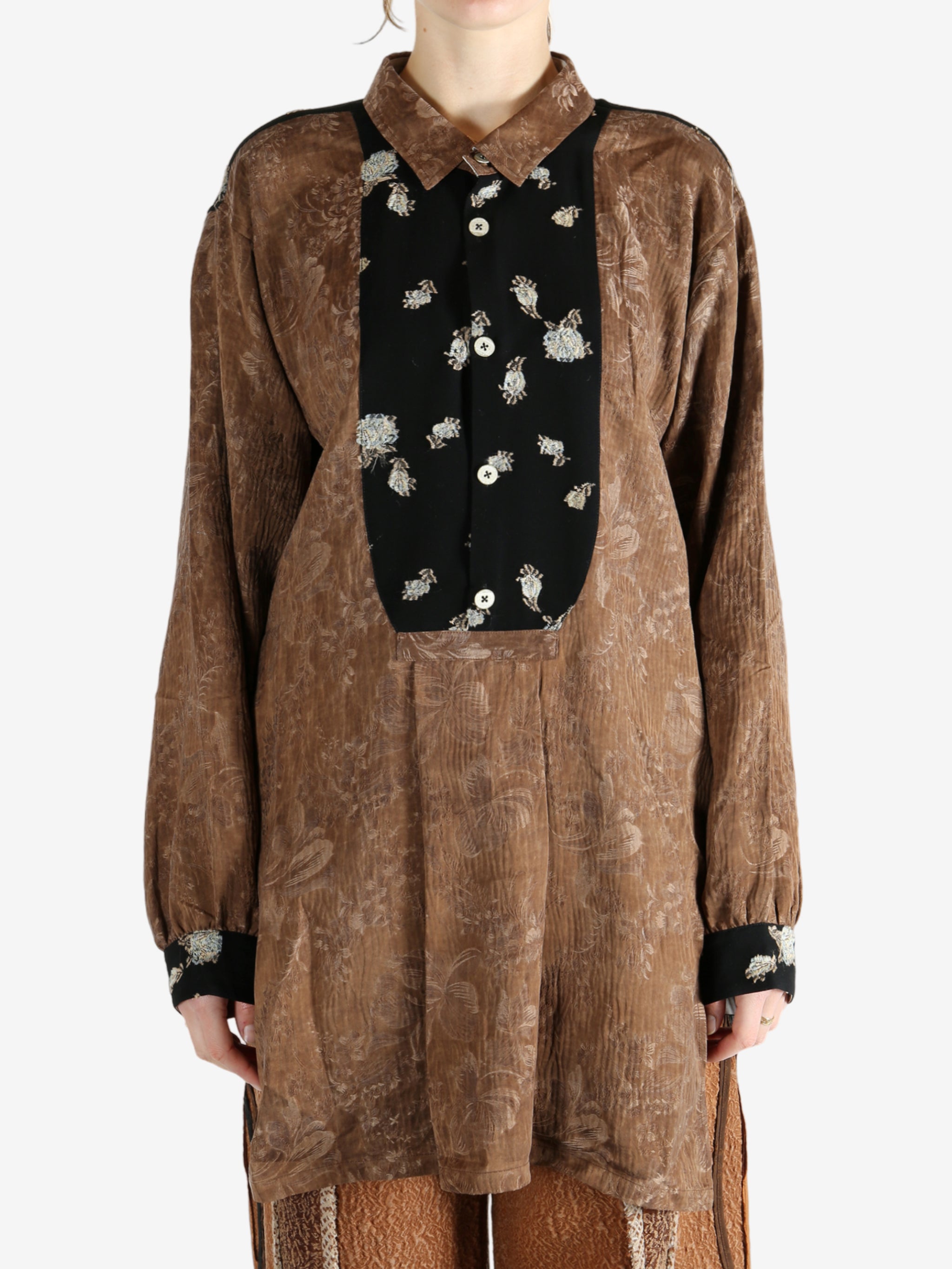 Brown shirt worn by a person, showing the shirt's fit