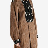 Brown shirt worn by a person, showing the shirt's fit