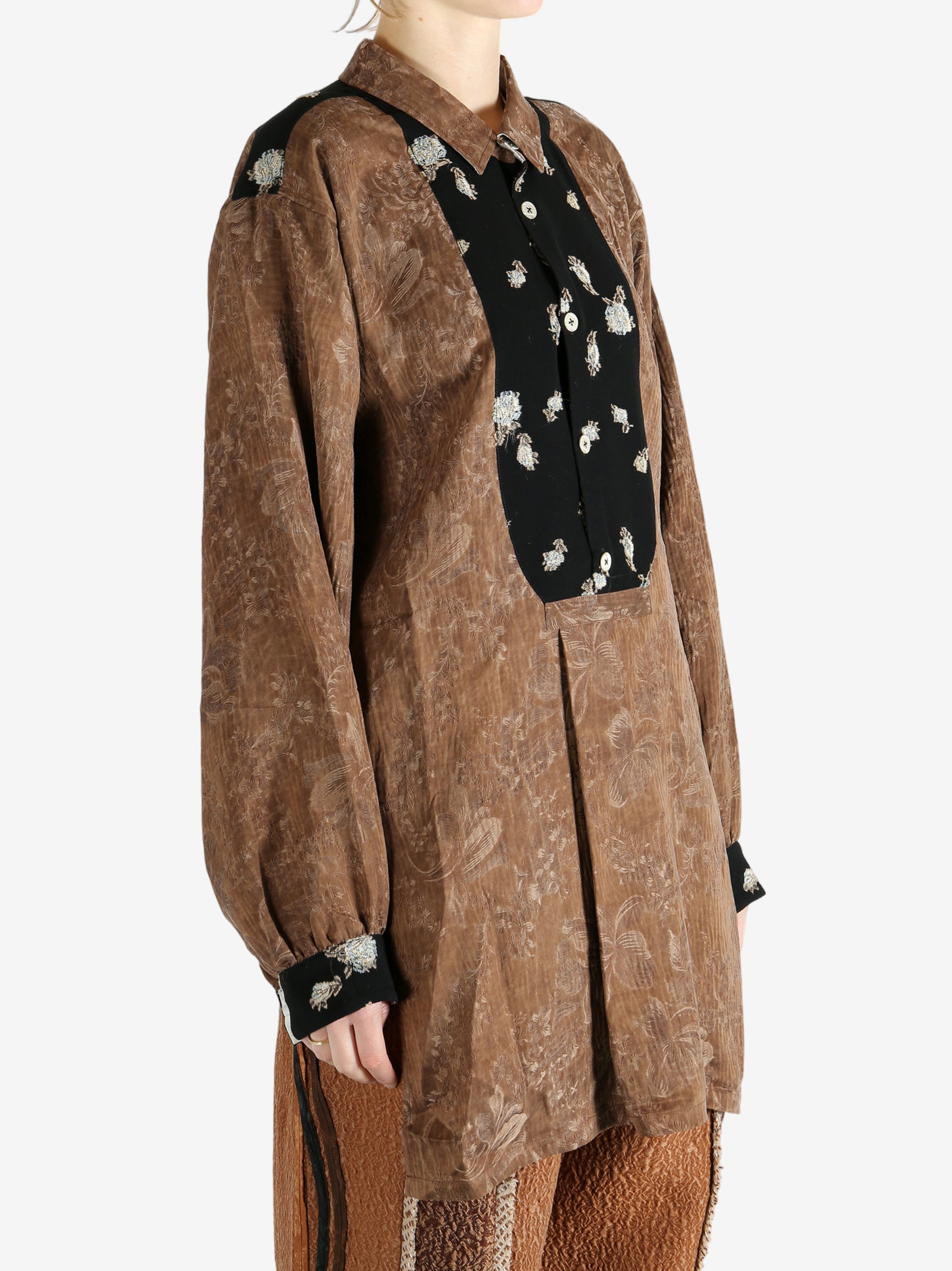 Brown shirt worn by a person, showing the shirt's fit