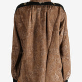 Brown shirt worn by a person, showing the shirt's fit