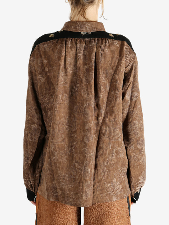 Brown shirt worn by a person, showing the shirt's fit