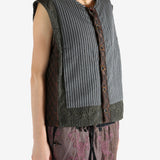 Grey vest worn by a person, showing the vest's fit