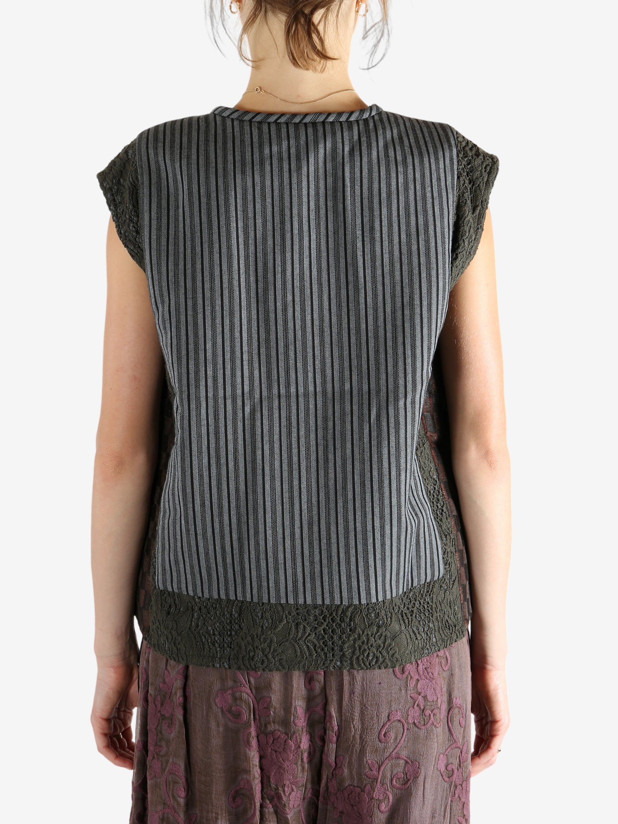 Grey vest worn by a person, showing the vest's fit