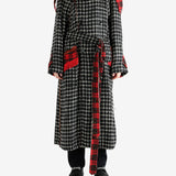 Black coat worn by a person, showing the coat's fit