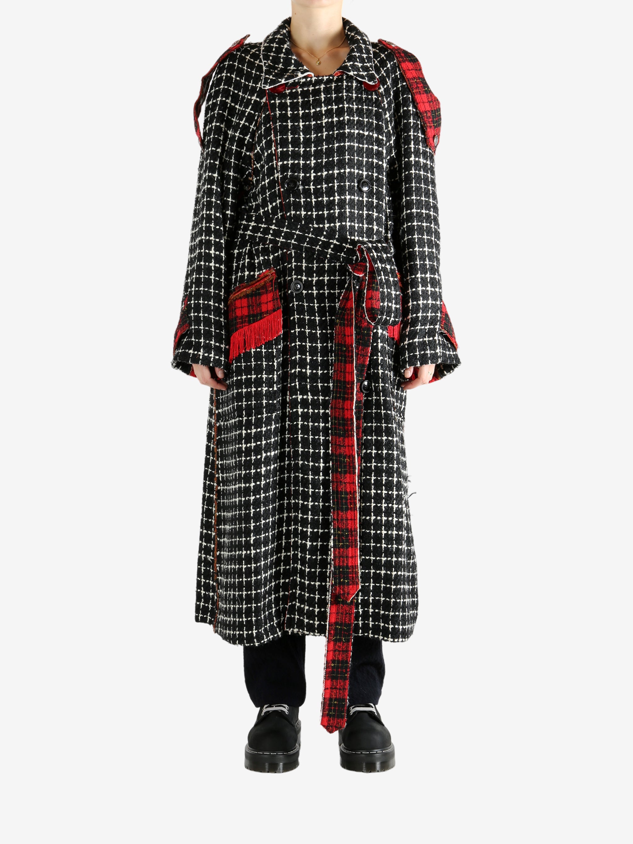 Black coat worn by a person, showing the coat's fit