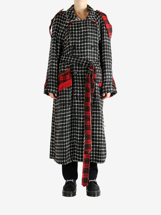 Black coat worn by a person, showing the coat's fit