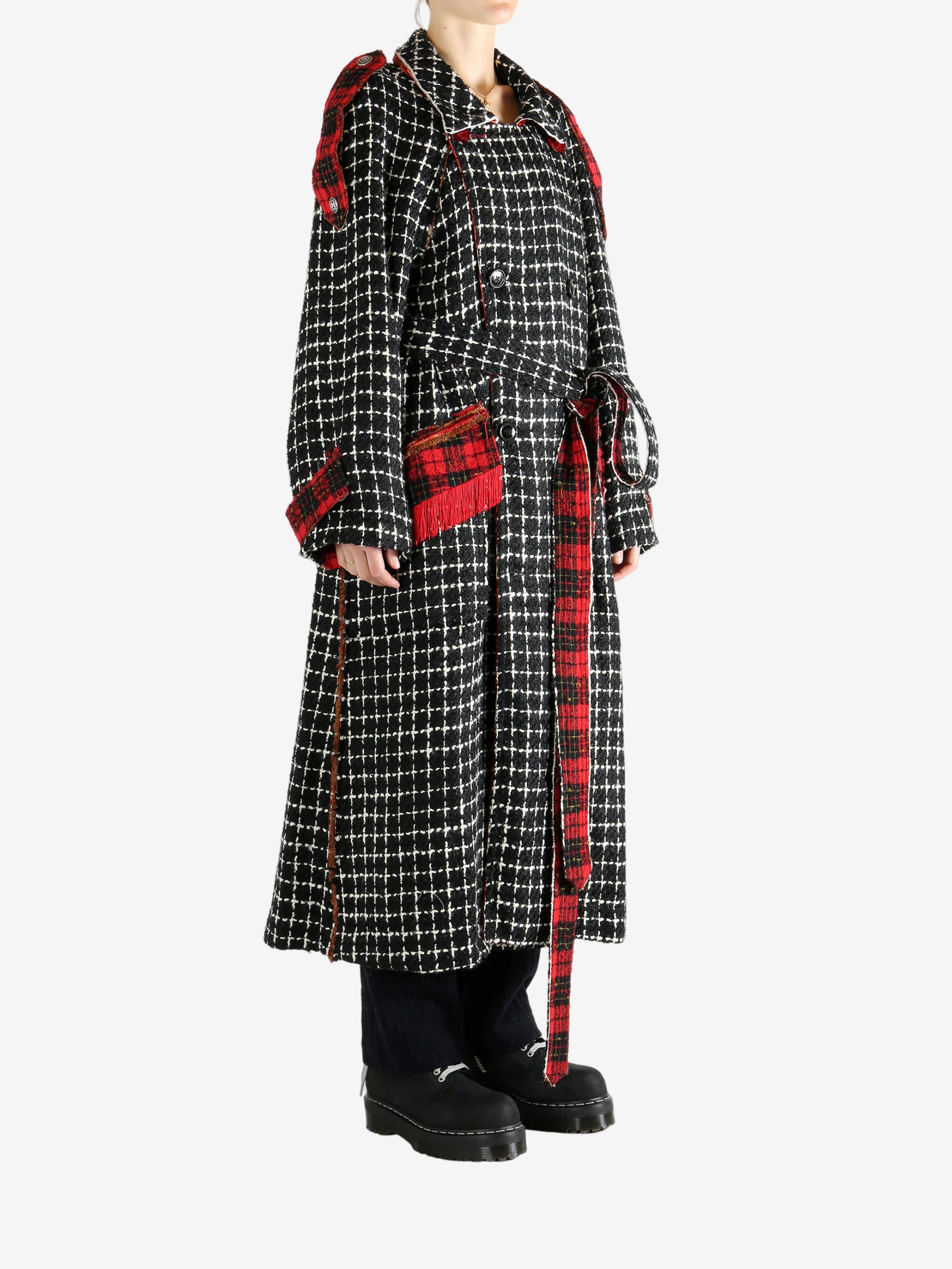 Black coat worn by a person, showing the coat's fit