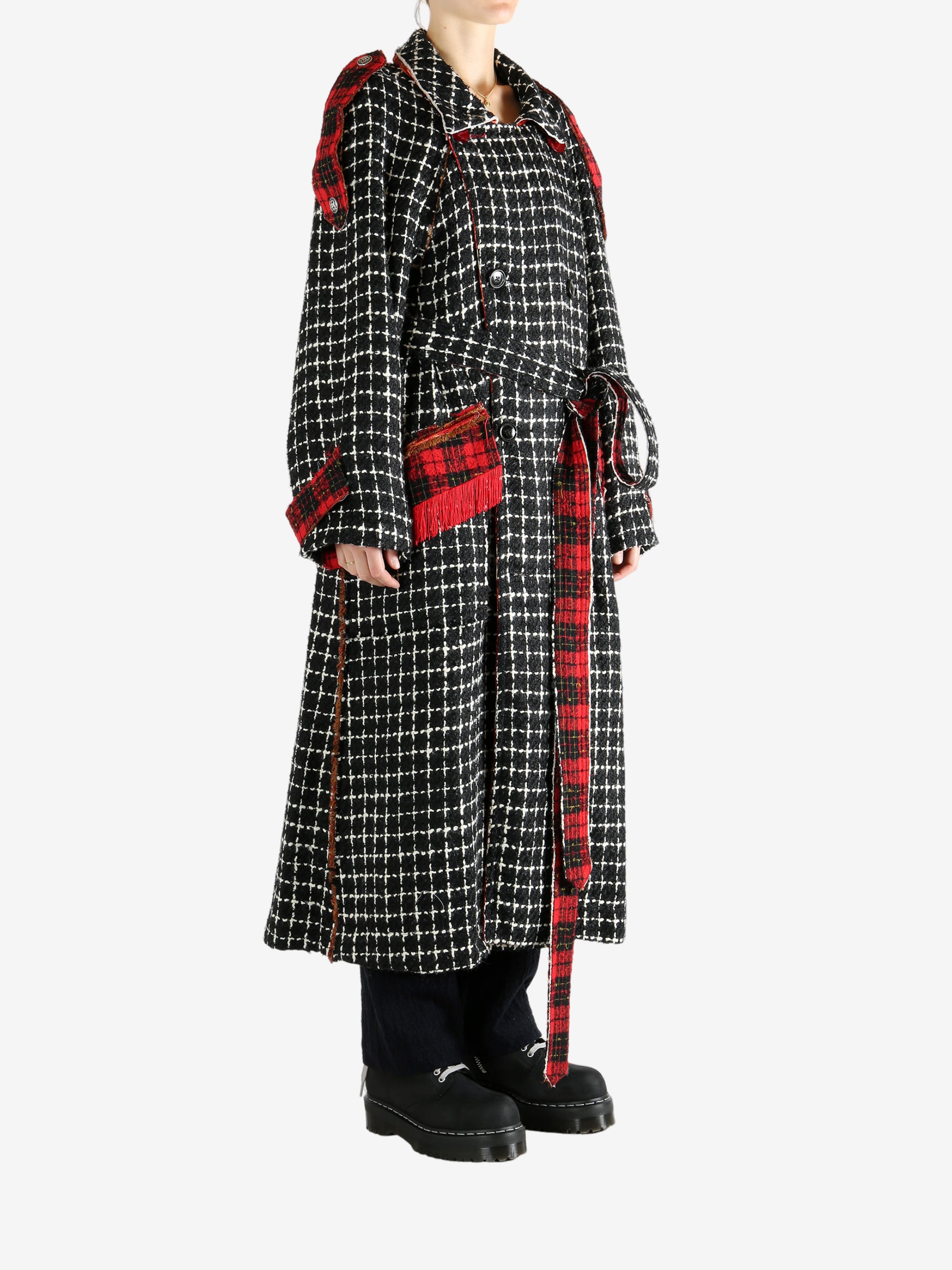 Black coat worn by a person, showing the coat's fit