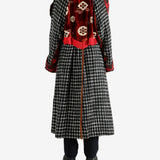 Black coat worn by a person, showing the coat's fit