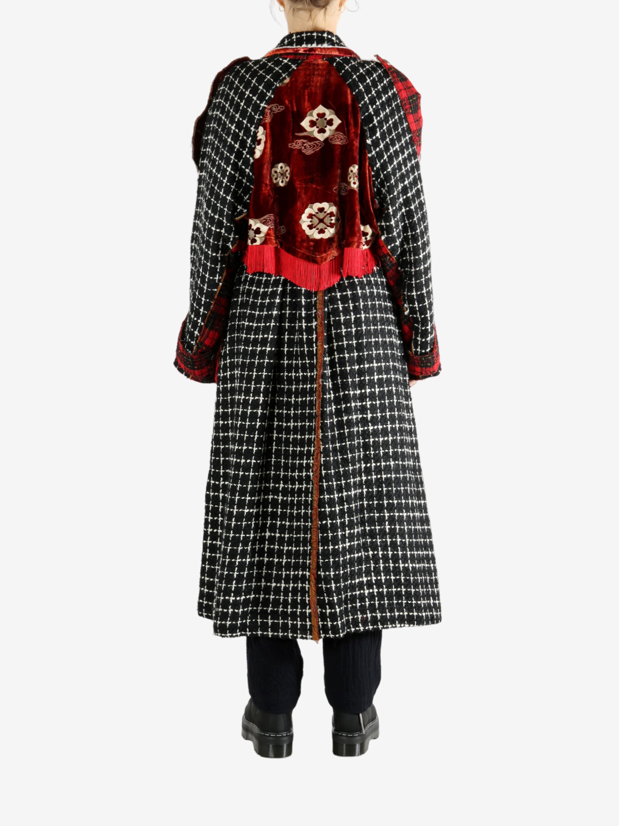 Black coat worn by a person, showing the coat's fit