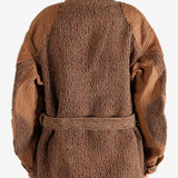 Brown jacket worn by a person, showing the jacket fit