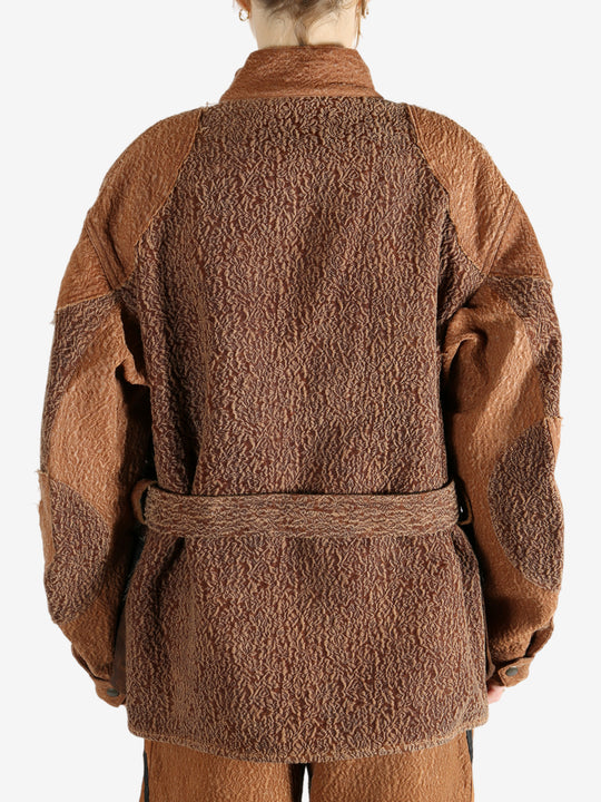 Brown jacket worn by a person, showing the jacket fit