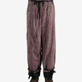 Purple pants worn by a person, showing the pants's fit