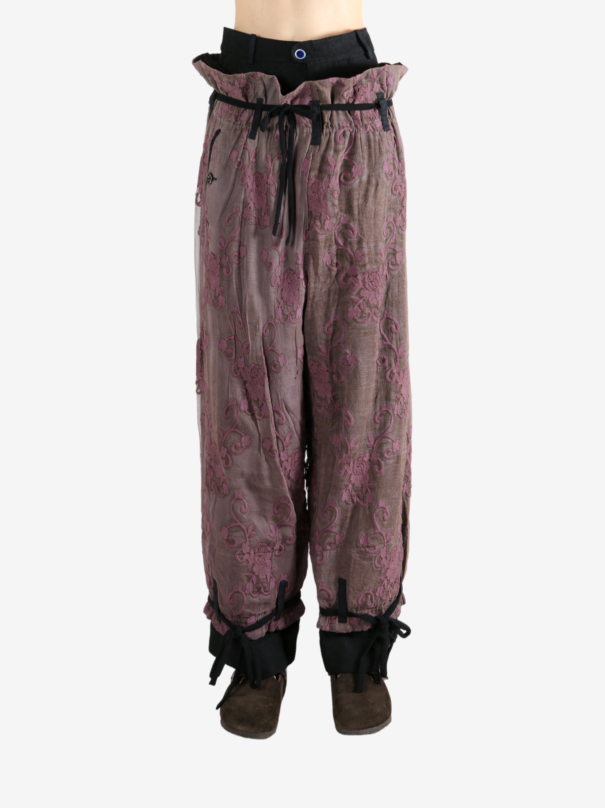 Purple pants worn by a person, showing the pants's fit